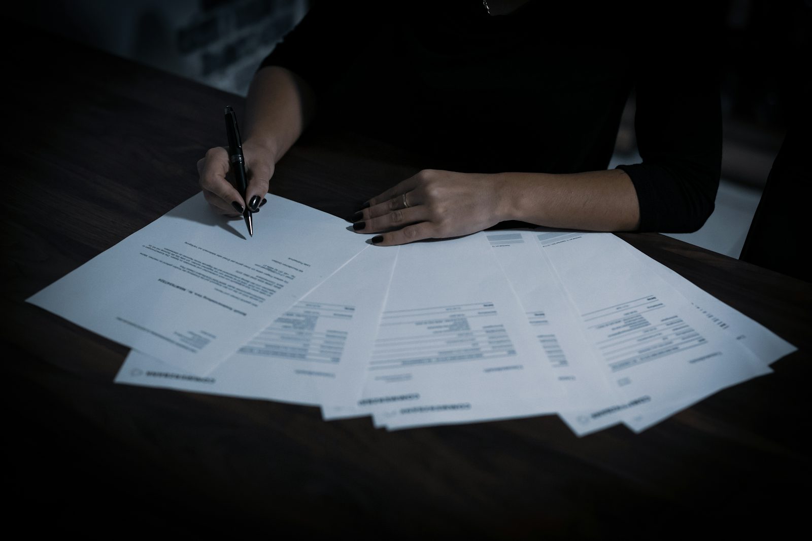 Two similar documents side by side on a desk, suggesting comparison