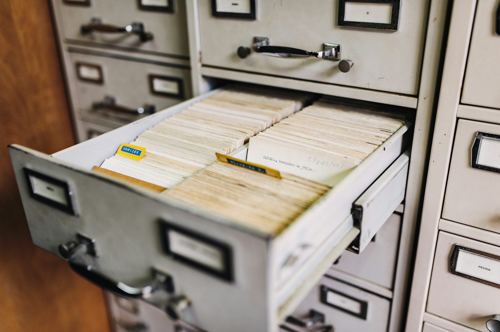 Organized labeled folders and files in a records drawer