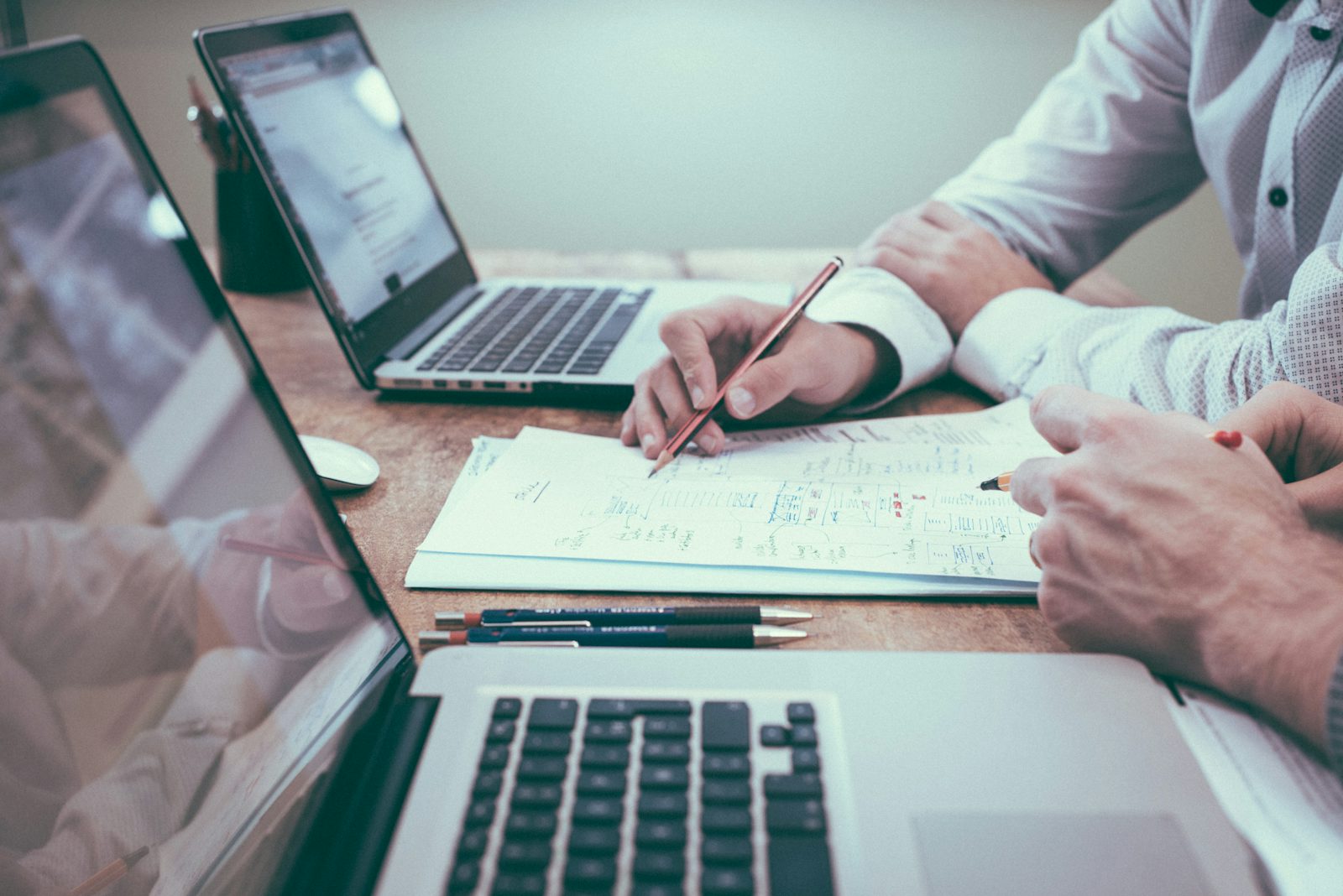 Two people reviewing a contract document across a desk